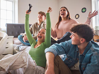 Teens playing games console